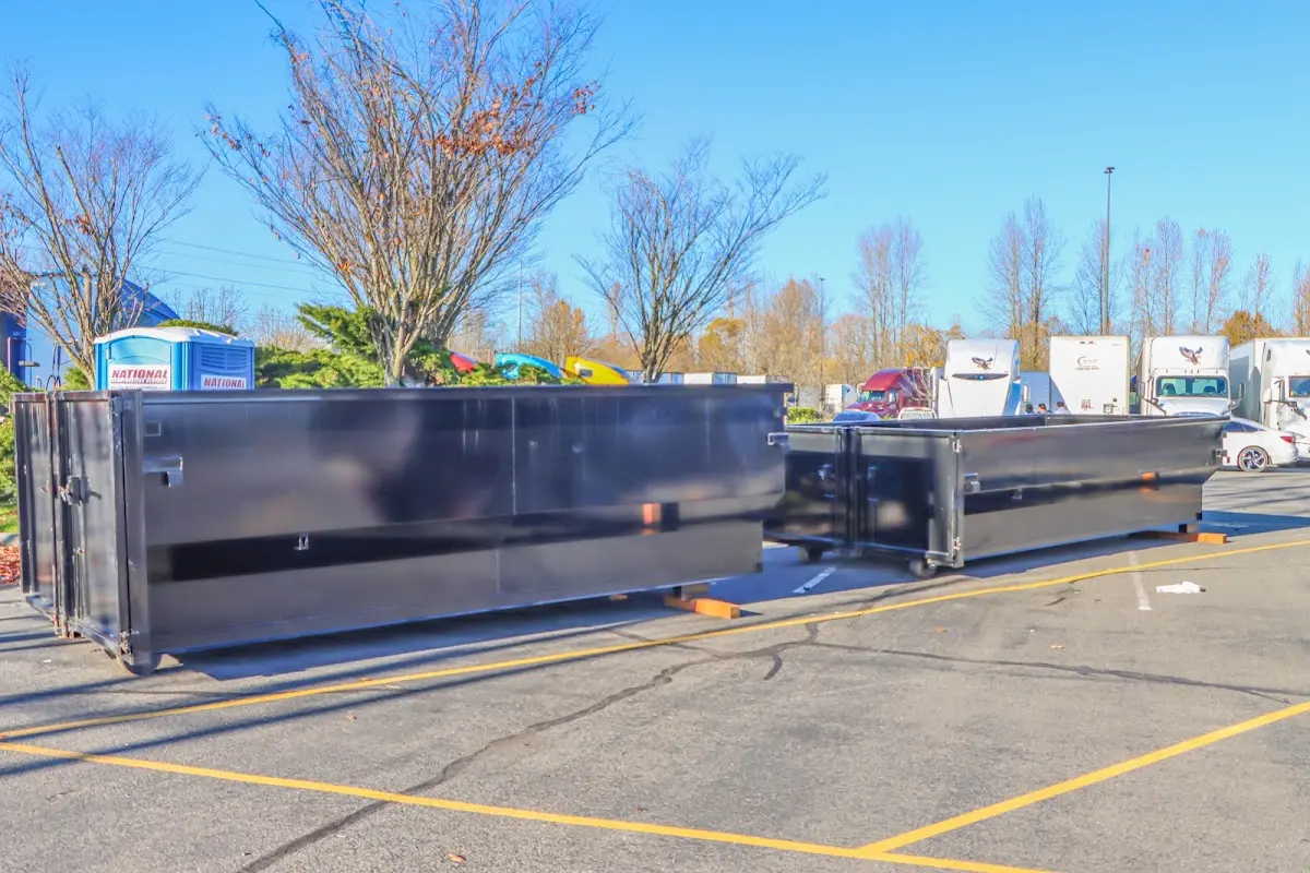 Professional dumpster rental service with roll-off container on residential driveway in New Iberia